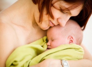 Mother holding sleeping baby girl